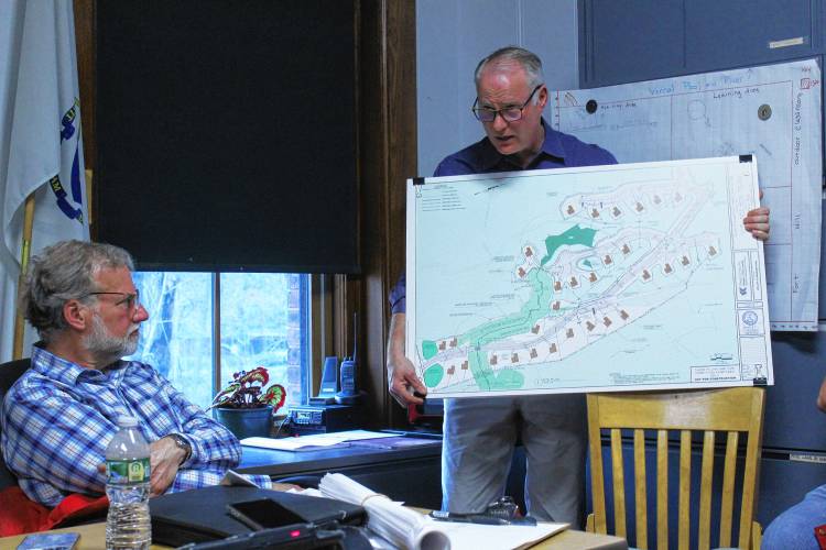 Charlemont Planning Board Chair Bob Nelson, left, looks on as civil engineer Jim Scalise, employed by Jeffrey and Jennifer Neilsen, details plans for 32 “glamping” cabins as part of the Hinata Mountainside Resort proposed for 133 Warfield Road in Charlemont.