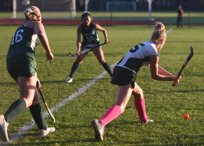Greenfield’s Gloria McDonald (5) looks to clear the ball from danger while defended by Minnechaug’s Nora Dumala (16) during the Green Wave’s 2-1 Suburban League loss on Wednesday in Greenfield.