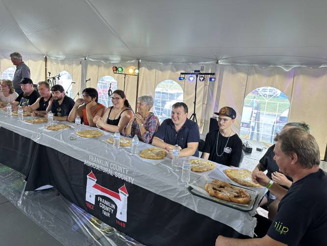 Competitive eaters prepare to dig in during the 2023 Franklin County Fair’s annual fried dough eating contest.