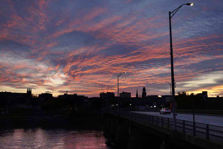 The skyline of in Lewiston, Maine on the Androscoggin River is seen at dawn, Thursday, Oct. 26, 2023. Residents have been ordered to shelter in place as police continue to search for the suspect of Wednesday's mass shooting at a local bar. (AP Photo/Robert F. Bukaty)