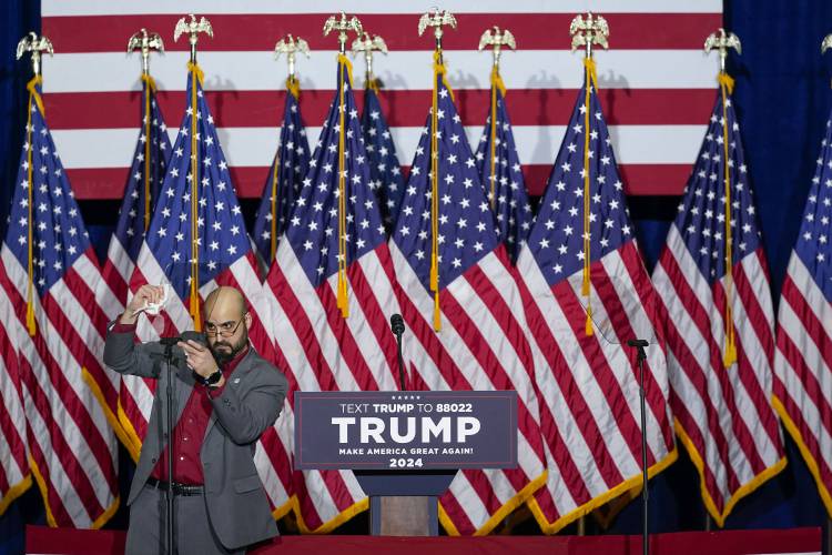A member of the campaign on stage making the final adjustments on the teleprompter before the appearance of Republican presidential candidate former President Donald Trump at a caucus night party in Des Moines, Iowa, Monday, Jan. 15, 2024.