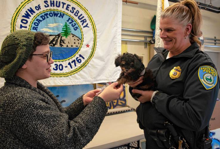 Shutesbury Town Clerk Grace Bannasch, left, and Police Chief Kristin Burgess swear in Charlie, a 9-week-old comfort dog, to the town’s Police Department. “People see him and immediately melt,” said Bannasch.