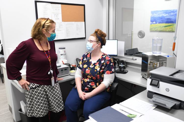 Dr. Ruth Potee, medical director for substance use disorders at Behavioral Health Network, talks with nurse Shelly Rice at BHN’s offices on New Athol Road in Orange when the clinic opened in late 2021. Since BHN opened its Orange clinic, the North Quabbin region has seen a 40% decrease in overdose deaths.
