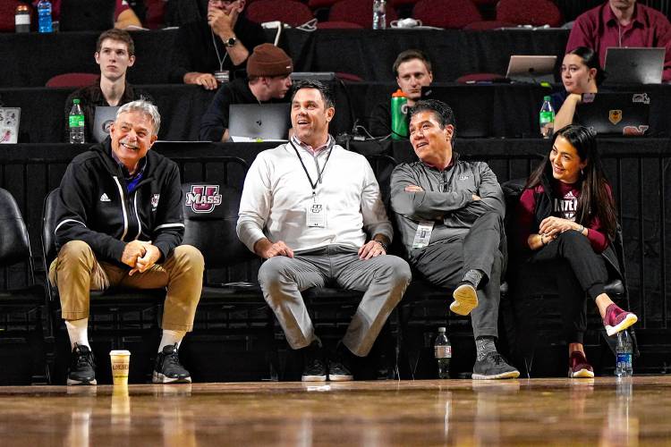 From left to right: UMass football coach Don Brown, athletic director Ryan Bamford, chancellor Javier Reyes and his wife Maritza Reyes watch the men’s basketball team’s season opener against Albany on Tuesday night at the Mullins Center.