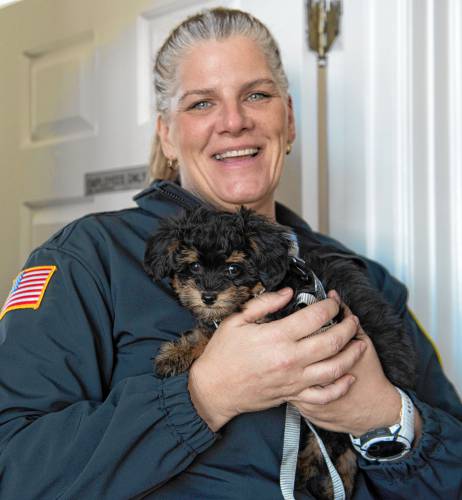 Shutesbury Police Chief Kristin Burgess holds Charlie, a 9-week-old comfort dog. “He specializes in cuddles and love,” said Burgess.