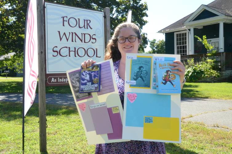 Becca Danielsen, English language arts teacher and co-director of Four Winds School in Gill, with some of her curriculum’s new graphic novels and associated work.