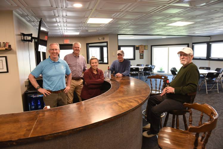 Jay Dillon, Ron Sicard and manager Sam Roussel behind the bar with members Dennis Chaffee and Tim Mahoney in the renovated clubhouse at Thomas Memorial Golf & Country Club in Turners Falls.
