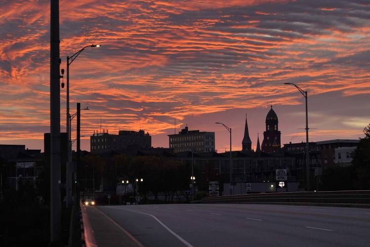 The skyline of in Lewiston, Maine is seen at dawn, Thursday, Oct. 26, 2023. Residents have been ordered to shelter in place as police continue to search for the suspect of Wednesday's mass shooting at a local bar. (AP Photo/Robert F. Bukaty)