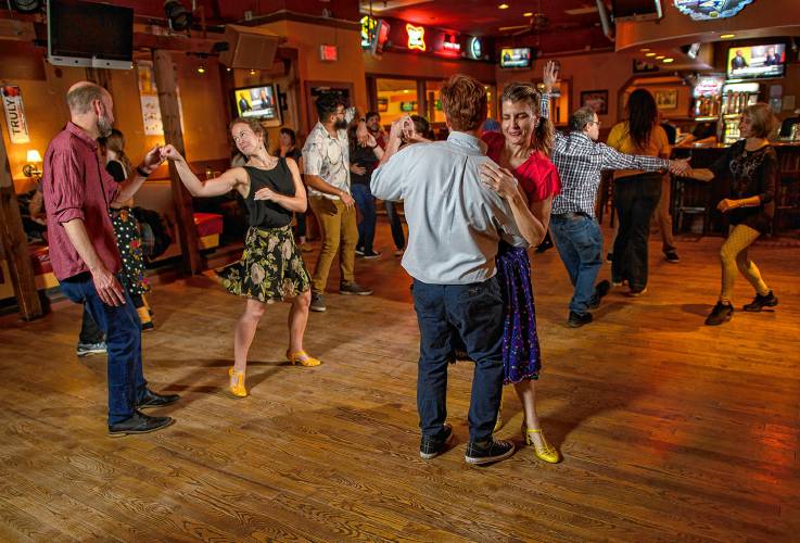 Swing dancers participate in a weekly dance organized by the Lindy League of Western Massachusetts at Spare Time Northampton and City Sports Grille.