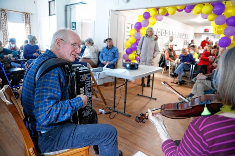 Craig Hollingsworth, left, and Cynthia Thomas play music for the dozens of community members gathered at Leverett Town Hall during the town’s 250th anniversary celebrations on Saturday.