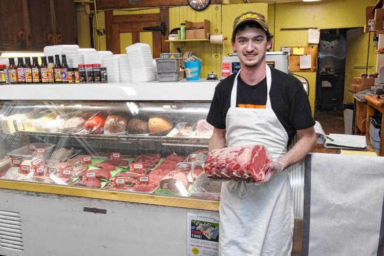 Jesse Snow with a standing rib roast at Marshalls Country Store in Bernardston.