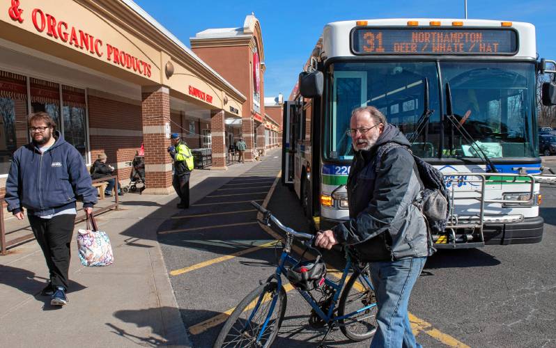 David Grace of Greenfield gets his bike off the bus at the Big Y stop in Northampton. “These buses are very important for grocery shopping. It’s crucial,” he said.