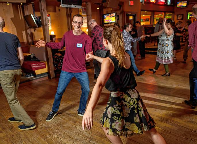 Joey Newlin of North-ampton, left, dances with Anna Leschen-Lindell of Montague during a weekly swing dance.