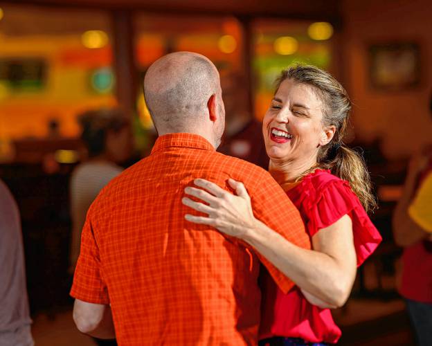 Northampton resident Johannah Hetherington shares a laugh with her dance partner during a weekly swing dance.