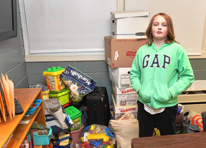 Griffin Haffner, 11, with children’s items donated to his family at Buckland-Shelburne Elementary School. They lost everything in a fire on Saturday.
