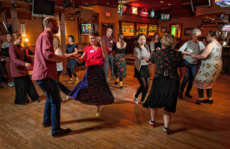 Swing dancers participate in a weekly dance organized by the Lindy League of Western Massachusetts at Spare Time Northampton and City Sports Grille.