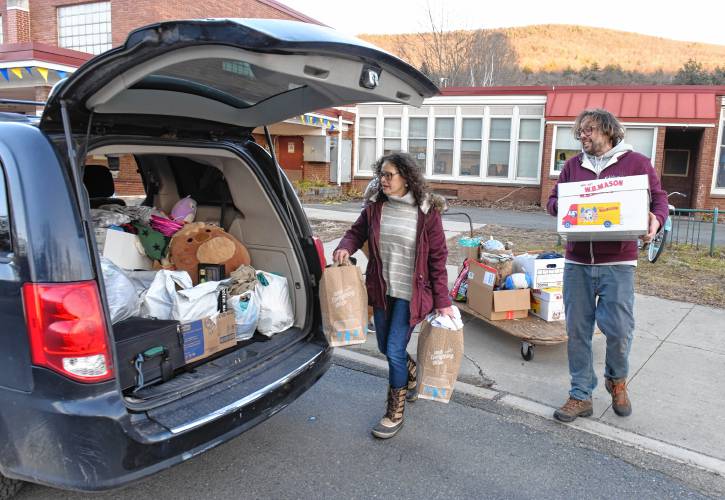 Cassandra and Grant Haffner load their vehicle with donations from the Buckland-Shelburne Elementary School community on Wednesday. The family lost everything in a fire on Saturday.