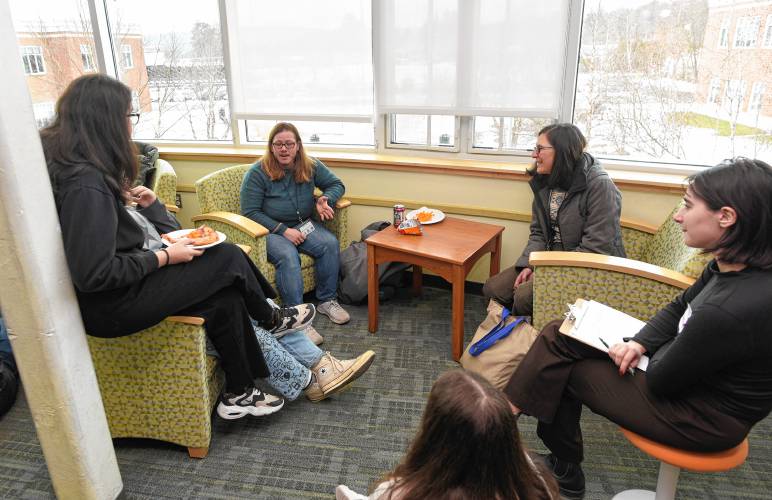 Greenfield School Committee member Stacey Sexton and Rachel Stoler of the Franklin Regional Council of Governments talk to students in the Greenfield High School library during the YELO (Youth Engage with Legislators and Officials) forum on Thursday.