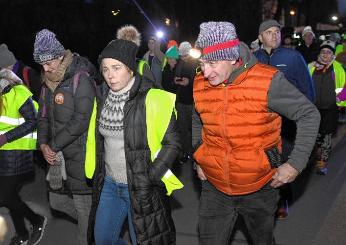 Gov. Maura Healey walks with Andrew Morehouse, executive director of the Food Bank of Western Mass., on Tuesday during its 14th annual march.
