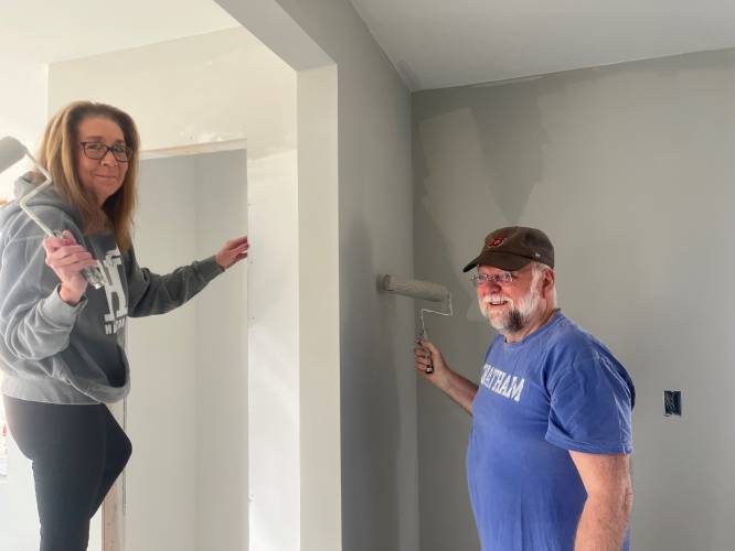 Lisa Kmetz and Michael Turley of Greenfield Cooperative Bank recently volunteered to help paint a Pioneer Valley Habitat for Humanity house.