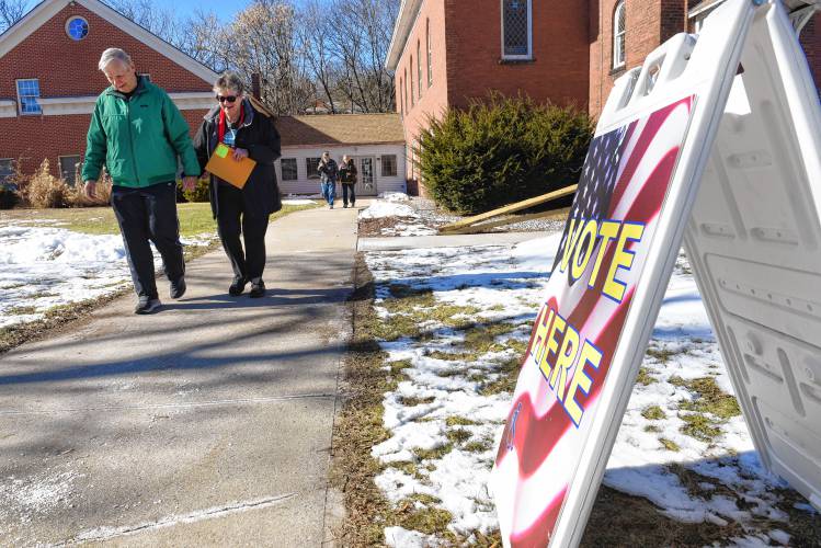 People leave after casting their votes at 62 Cheney St. in Orange on Monday.