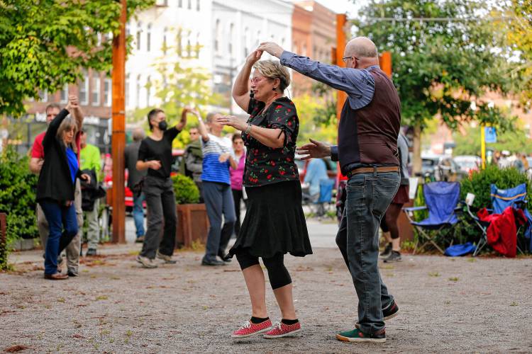 Instructors Christine LeBel and Mark Page teach an east coast swing dance class for the public gathered at Pulaski Park during the Northampton Jazz Festival.