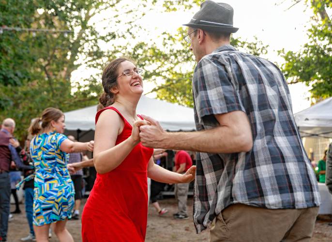 Greg Perham, right, and Carrie Bernstein dance along with the hundreds of swing music lovers gathered over the course of Saturday evening to dance to the music of Danny Jonokuchi & The Revisionists at Pulaski Park during the Northampton Jazz Festival.