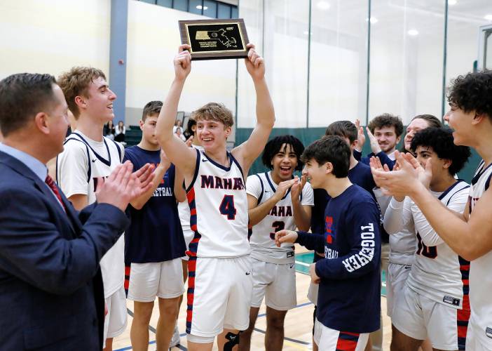 Mahar celebrates after receiving the Western Mass. Class C boys basketball championship plaque Saturday against Granby at Holyoke Community College.