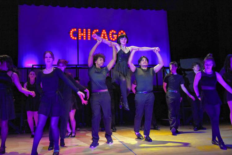 Students involved with the production of the spring musical “Chicago” rehearse a scene in the Turners Falls High School auditorium on Monday.