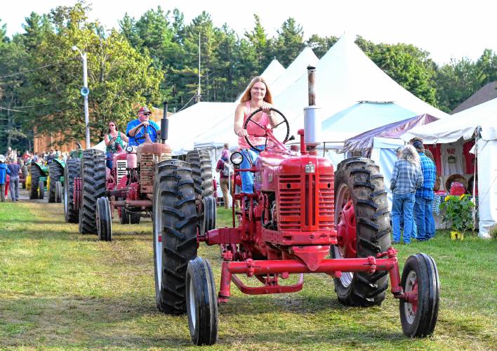 The Antique Tractor Parade at the Heath Fair on Friday night.