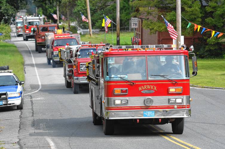 Fire engine sirens and flashing lights in the parade at the Warwick Old Home Days.