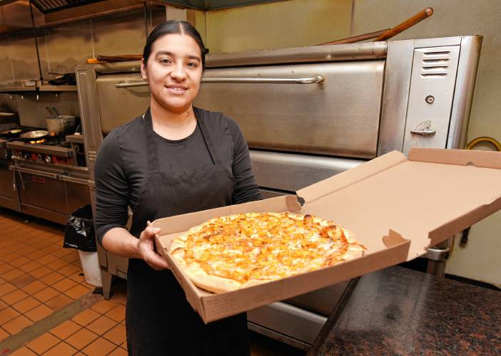 Claudia Rodas boxes up a pizza for delivery at Primo Restaurant & Pizzeria in South Deerfield. 