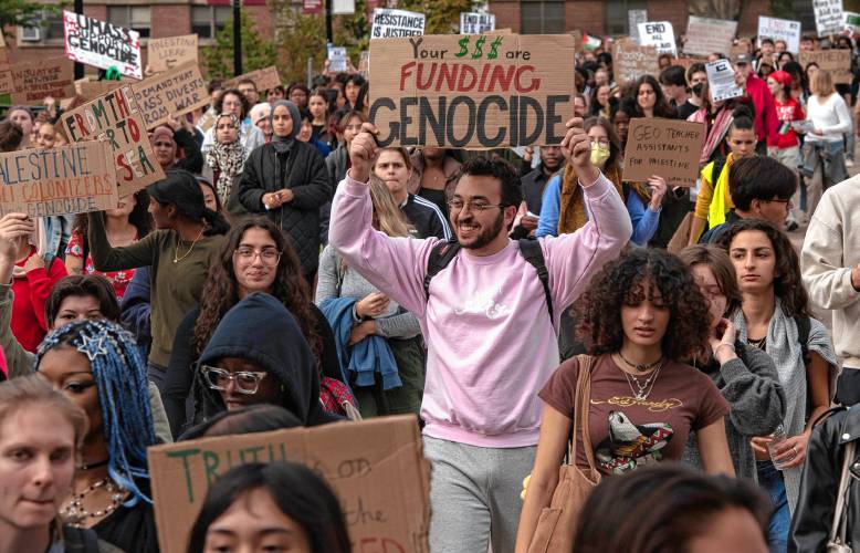 Hundreds of University of Massachusetts Amherst students walk to the chancellor’s office in  the Whitmore Administration Building during a walkout and sit-in event on Wednesday to demand that the university cut ties with weapons manufacturers and condemn Israeli actions in Gaza.