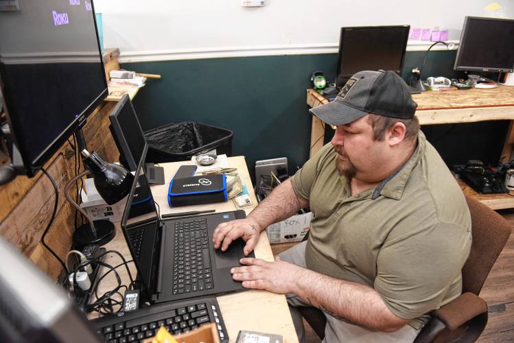 Jake Benedict works on a computer at Busy Bee Computers at 22 Federal St. in Greenfield.