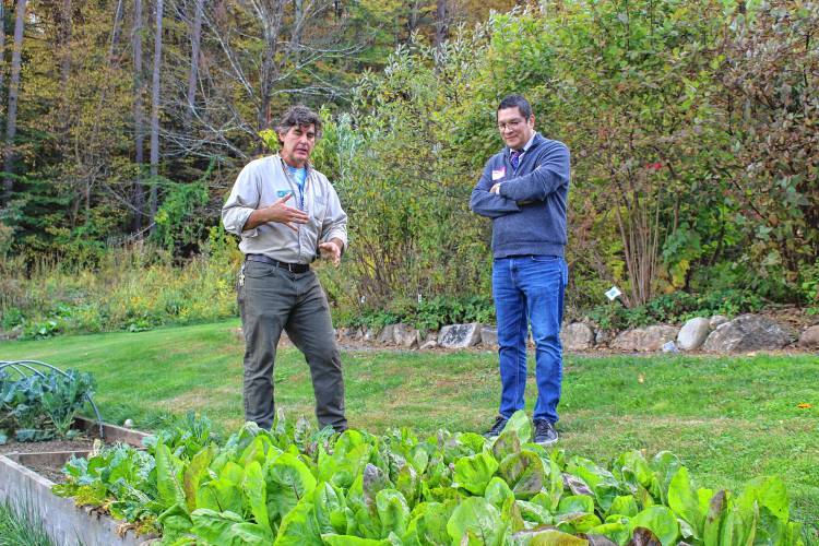 Anthony Reiber, left, who teaches science at Greenfield Community College, talks with Noe Ortega, the state’s higher education commissioner, over some radicchio in GCC’s Outdoor Learning Lab during Ortega’s visit capping off STEM Week on Thursday.