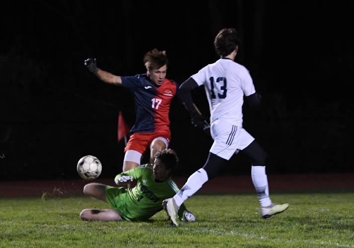 Frontier’s Rosco Palmer leaps over Monomoy goalie Paul Carlson in South Deerfield on Wednesday. Monomoy’s Owen Ramler was in pursuit.
