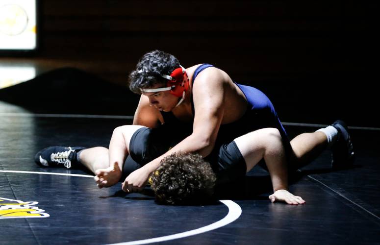 Frontier’s Javion Cabrera, top, competes against Smith Vocational’s Colin Pascal in the 285-pound weight class earlier this season in Northampton. 