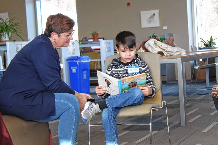 Michael, 7, and Kim Zabek read a children’s book on Martin Luther King Jr.’s life during a story hour at Greenfield Community College’s 25th annual Martin Luther King Jr. Day celebration.