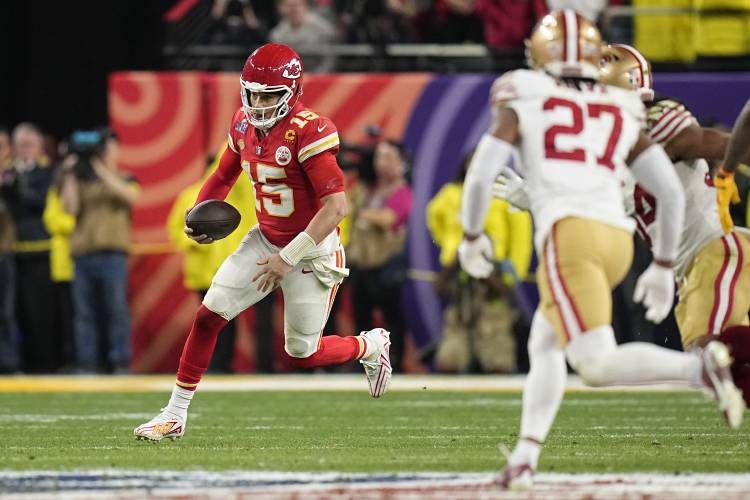 Kansas City Chiefs quarterback Patrick Mahomes (15) runs for a first down against the San Francisco 49ers during overtime in the NFL Super Bowl 58 football game Sunday, Feb. 11, 2024, in Las Vegas. (AP Photo/Eric Gay)