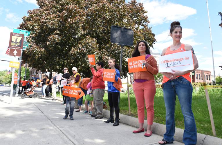 On National Gun Violence Awareness Day in 2017, a group wearing orange encouraged gun safety on the Greenfield Common. As this year’s awareness day approaches, organizers are seeking the community’s help in crafting orange hearts inscribed with the names of victims of gun violence.