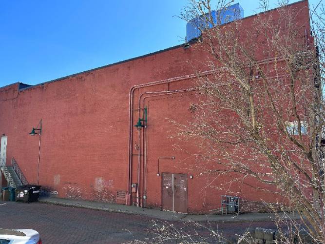 A steering group has selected North Carolina-based muralist Darion Fleming to paint a 3,200-square-foot mural on the east exterior wall, pictured, of the Shea Theater Arts Center in Turners Falls.