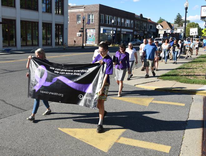 Participants walk from the Episcopal Church of Saints James and Andrew to the Greenfield Common on Aug. 31, 2022 to recognize International Overdose Awareness Day.