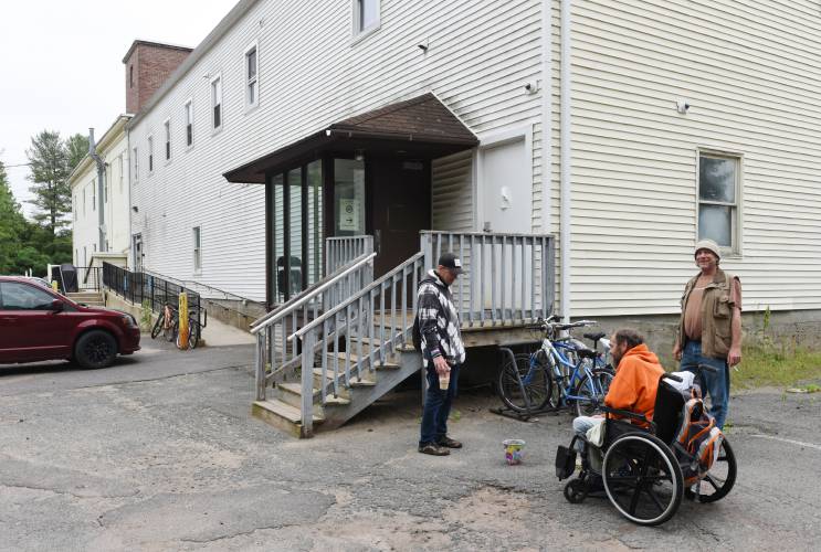 Guests socialize outside the homeless shelter on Wells Street in Greenfield, which is now run by Clinical & Support Options, in June 2022. It was formerly operated by ServiceNet.
