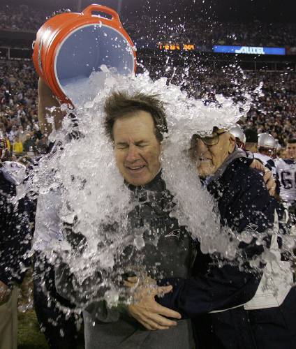 FILE - New England Patriots head coach Bill Belichick is doused after the Patriots beat the Philadelphia Eagles 24-21 in Super Bowl XXXIX at Alltel Stadium in Jacksonville, Fla., Feb. 6, 2005. At right is Belichick's father, Steve. Six-time NFL champion Bill Belichick has agreed to part ways as the coach of the New England Patriots on Thursday, Jan. 11, 2024, bringing an end to his 24-year tenure as the architect of the most decorated dynasty of the league’s Super Bowl era, a...