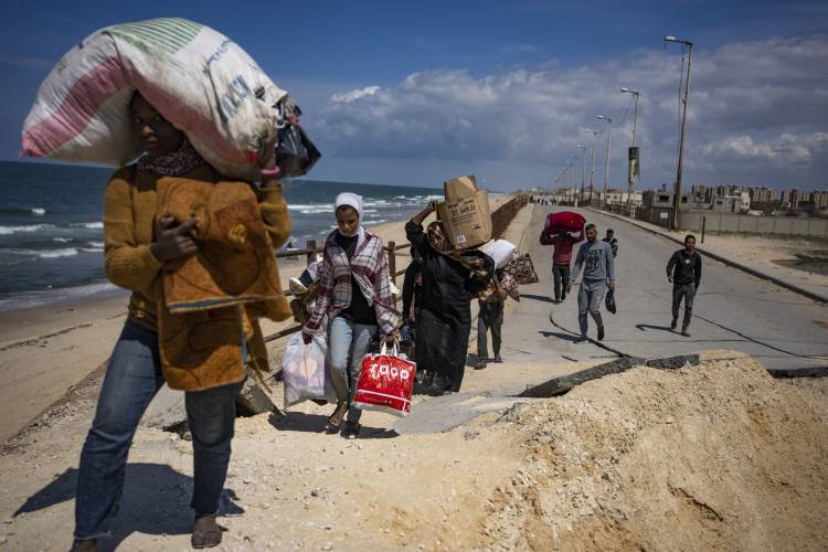 Palestinians flee Gaza City to the southern Gaza Strip, in Wadi Gaza, Monday, March 25, 2024.