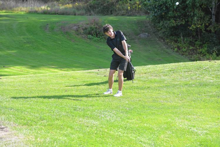 Greenfield’s Bryce Avery chips onto Hole No. 2 during a match against Athol at the Country Club of Greenfield on Wednesday.