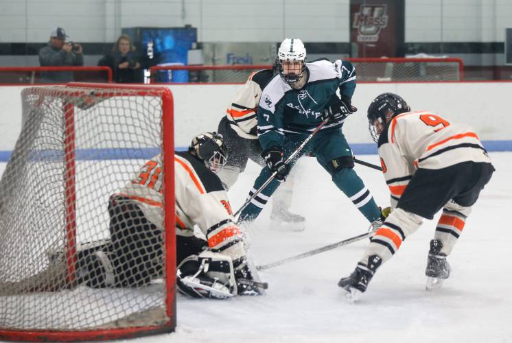 Greenfield’s Hunter Smith (7) fires a shot on Belchertown goalkeeper Curtis Wojnas before putting the rebound in for a goal in the second period last season at the Mullins Center Community Rink in Amherst.
