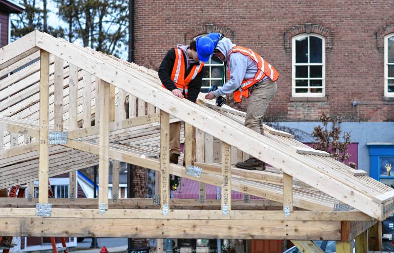 Franklin County Technical School carpentry students work on roof trusses at the pavilion build in Shelburne Falls. 