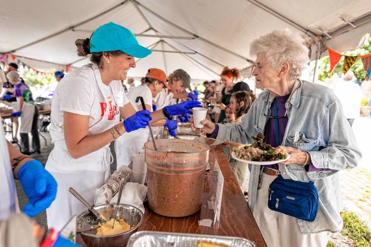 Volunteers serve food at Saturday’s Harvest Supper.