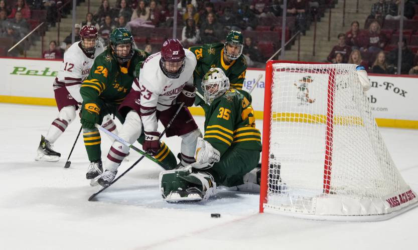 UMass’ Scott Morrow (23) crashes the Vermont net during the Minutemen’s 4-1 Hockey East victory on Friday at the Mullins Center in Amherst.